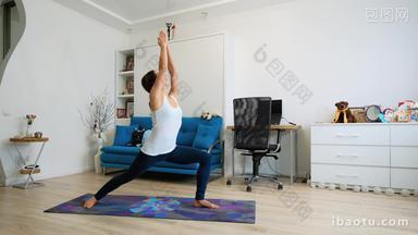 Young woman practicing <strong>yoga</strong> at home, standing in warrior position